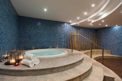 a bathroom with a jacuzzi tub and stairs at Concorde Hotel Doha in Doha