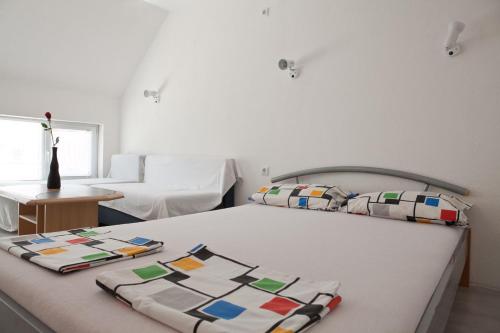 a bedroom with a bed with a quilt on it at Guest House Villa Rose in Primorsko