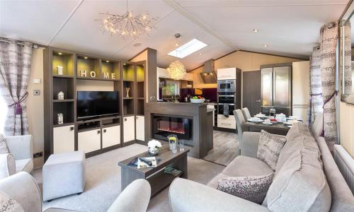 a living room with a couch and a fireplace at Lancashire Rose in Windermere