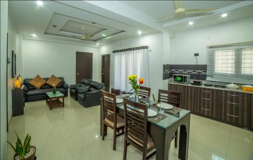 a kitchen and living room with a table and chairs at HILL VIEW JUBILEE HILLS in Hyderabad