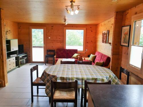 a room with a table and chairs and a living room at Carpe Diem 2 in Fiesch