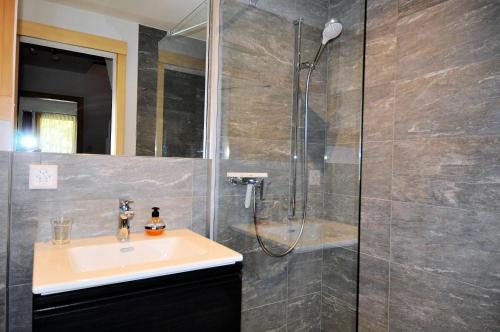 a bathroom with a sink and a shower at Carpe Diem 2 in Fiesch