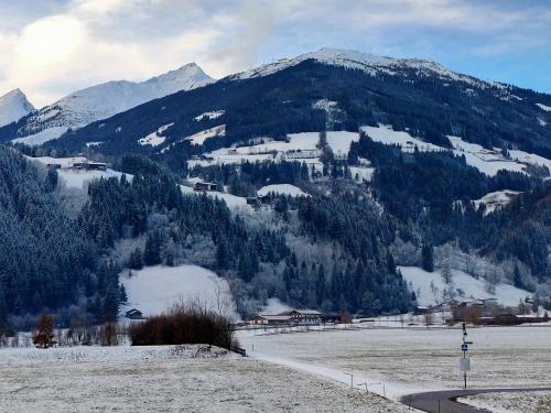 a snow covered mountain with a town in the foreground at Haus-Elisabeth in Uderns
