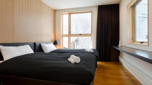 a hotel room with two beds and a window at Forest Estate in Kutchan