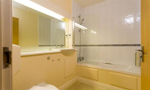 a bathroom with a sink and a shower and a tub at Troutbeck - Whitbarrow Village in Penrith