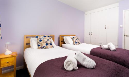 um quarto com 2 camas e toalhas em Bow Peak em Bowness-on-Windermere