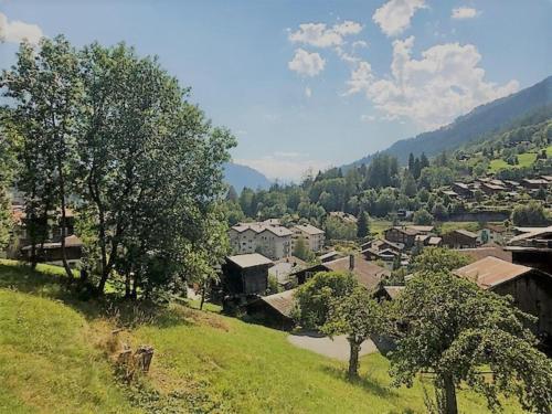 a small village with trees and houses on a hill at Aleid Sunshine in Fiesch