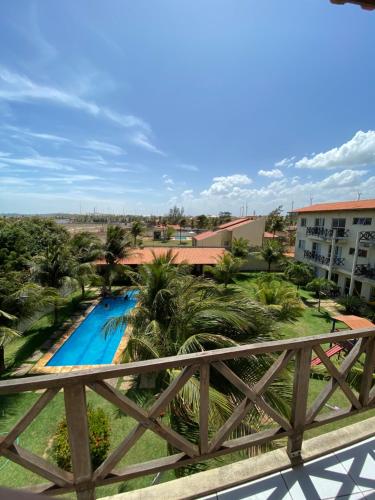 a view of the pool from the balcony of a resort at Apto Praia da Taíba Vista Mar in Taíba