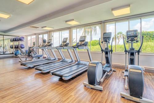 a gym with rows of treadmills and elliptical machines at Dreams Curacao Resort, Spa & Casino in Willemstad