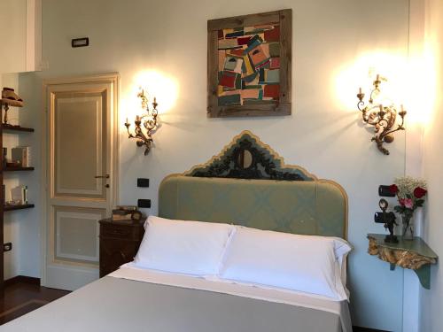 a bedroom with a bed and a painting on the wall at Agriturismo Collerisana in Spoleto