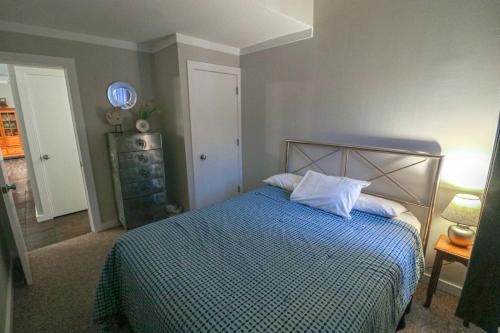 a bedroom with a bed with a blue comforter at Perfect four bedroom condo with shuttle to the mountain, ski Back Whiffletree D8 in Killington