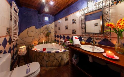 a bathroom with a tub and a toilet and a sink at Apartamentos La Suerte in Hinojares