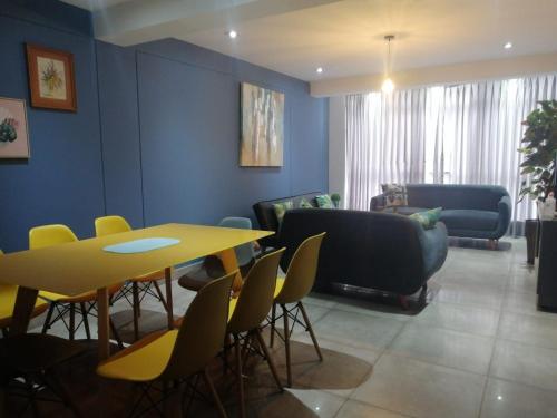 a waiting room with a table and chairs at Cusco Cozy Apartment in Cusco