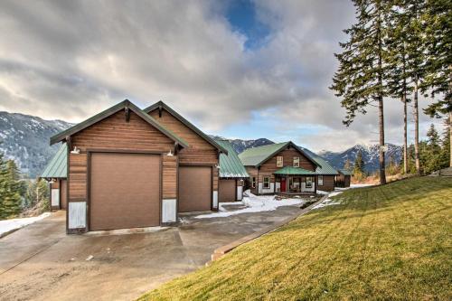 a house with a garage on a driveway at Cle Elum Lake Bunkhouse with Shared Hot Tub and Views! in Ronald