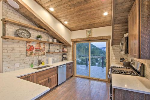 a kitchen with a sink and a large window at Cle Elum Lake Bunkhouse with Shared Hot Tub and Views! in Ronald