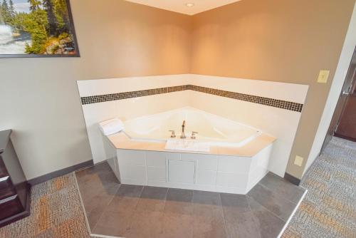 a bathroom with a tub and a sink at Canad Inns Destination Centre Polo Park in Winnipeg