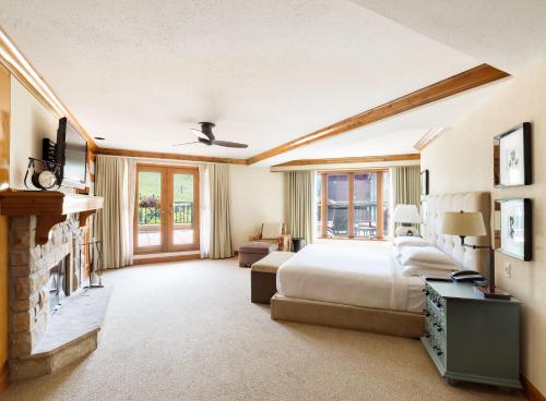 a bedroom with a bed and a fireplace at Park Hyatt Beaver Creek Resort and Spa, Vail Valley in Beaver Creek