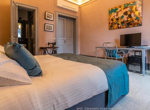 a bedroom with a large bed and a television at 360Me Palace in Messina