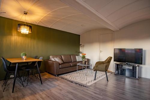 a living room with a couch and a table at Skagi Bed & Lodge in Skaland
