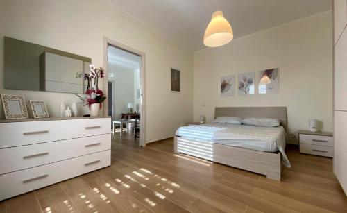 a bedroom with a bed and a dresser and a mirror at Casa Vacanze Marale in Castelmola