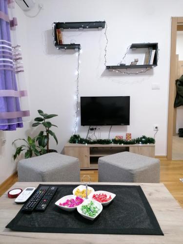 a living room with a table with bowls of food at Apartman San in Vrnjačka Banja