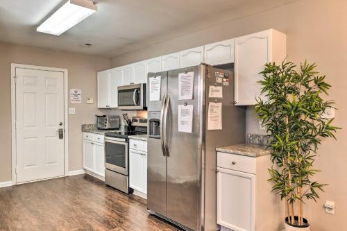 a kitchen with stainless steel appliances and white cabinets at Near UNCC! Charlotte Family Retreat with Deck in Charlotte
