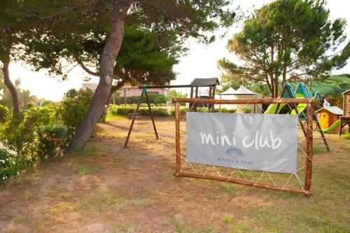 a sign that saysini club sitting in a park at BV Borgo Del Principe in Zambrone