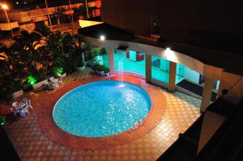 an overhead view of a swimming pool at night at Biss Inn Hotel in Goiânia