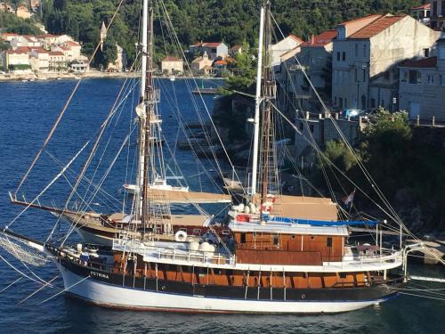 a large boat in the water next to a city at High View-A Seaside Villa With Huge Jacuzzi in Račišće