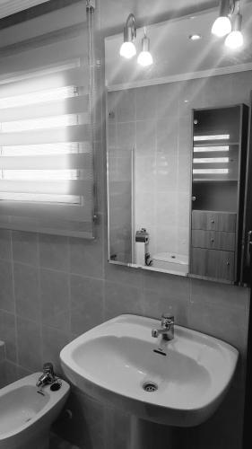 a bathroom with a sink and a mirror at Villa Albaida in La Zubia