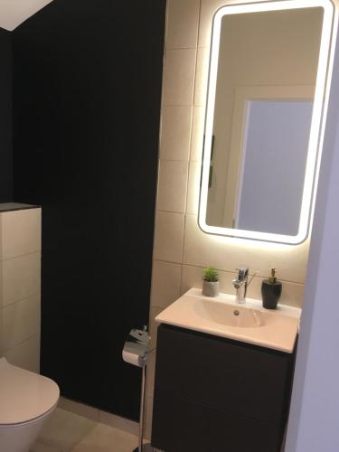 a bathroom with a sink and a mirror at High View-A Seaside Villa With Huge Jacuzzi in Račišće