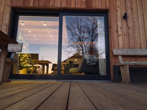 a large glass door with a view of a patio at Ferienhaus Königsdorf - Urlaub im Tölzer Land in Königsdorf