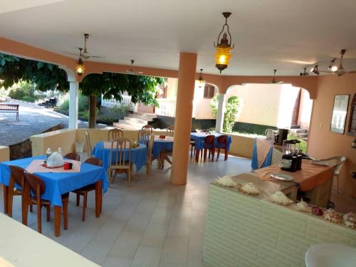 a restaurant with tables and chairs and blue tables and chairs at Safina Resort in Zanzibar City
