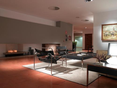 
a living room filled with furniture and a fireplace at Parador de Málaga Golf in Málaga

