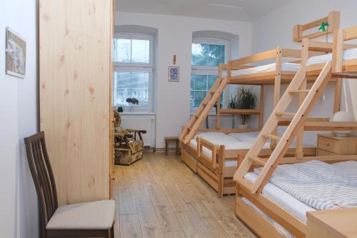 a room with two bunk beds and a chair at Apartmán Pod Černou Horou in Svoboda nad Úpou