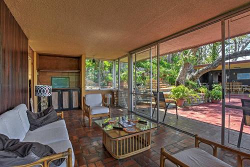 a living room with a large glass wall at Tropical Ponce Home Private Pool and Outdoor Oasis! in Ponce