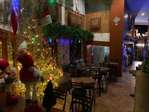 a christmas tree in a restaurant with christmas decorations at Quinta Maria Bonita Hotel Boutique in Xalapa