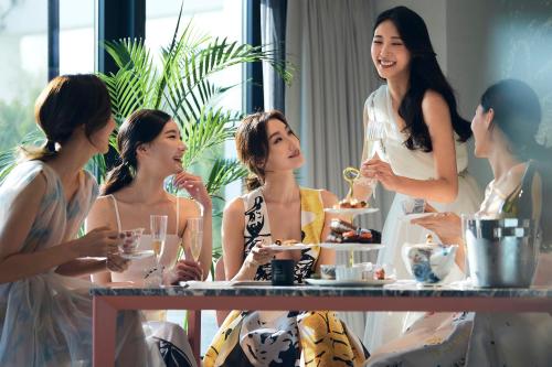 a group of women sitting around a table with wine glasses at Mondrian Seoul Itaewon in Seoul