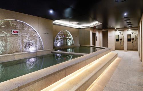 a bathroom with a pool of water in a building at Mondrian Seoul Itaewon in Seoul