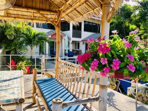 a porch with a bench and a potted plant at Angelot Villa in Chaweng Noi Beach