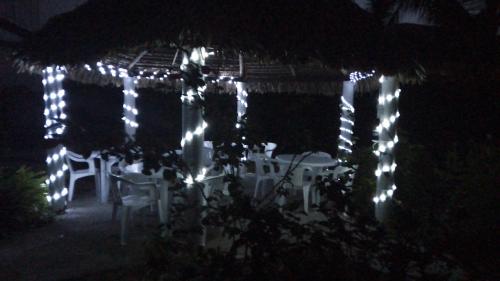 a gazebo covered in white lights at night at Villa kosniin in Tecolutla