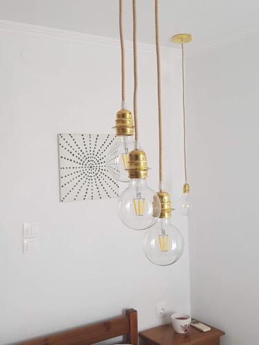a room with three lights hanging from the ceiling at Eleni B&B in Limánion