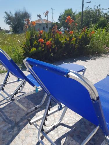 a pair of blue chairs sitting on a patio at Eleni B&B in Limánion