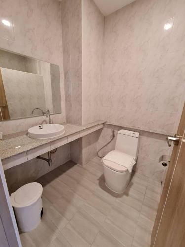 a bathroom with a toilet and a sink at The charlotte smart hotel lopburi in Lop Buri