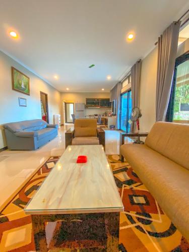 a living room with a couch and a coffee table at AL Marina Resort in Puncak