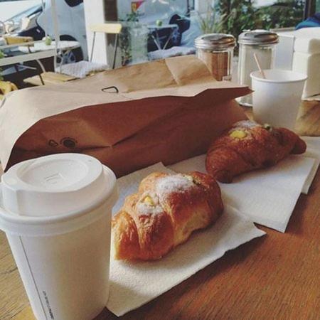 a table with two pastries and a cup of coffee at Hotel Kennedy in Rome