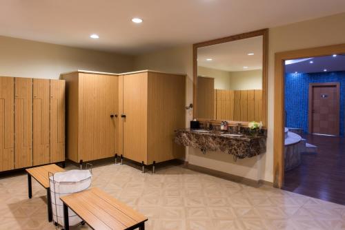 a waiting room with wooden lockers and a sink at Concorde Hotel Doha in Doha