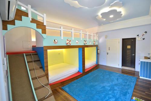 a childrens room with a bunk bed and a play floor at Happiness Childhood in Hualien City