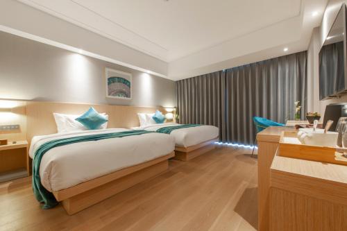 a hotel room with a bed and a sink at Shanghai Baixia Pagoda Hotel in Shanghai
