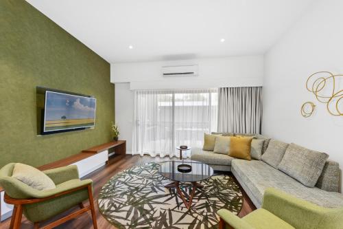 a living room with a couch and a table at Club Wyndham Flynns Beach, Trademark Collection by Wyndham in Port Macquarie